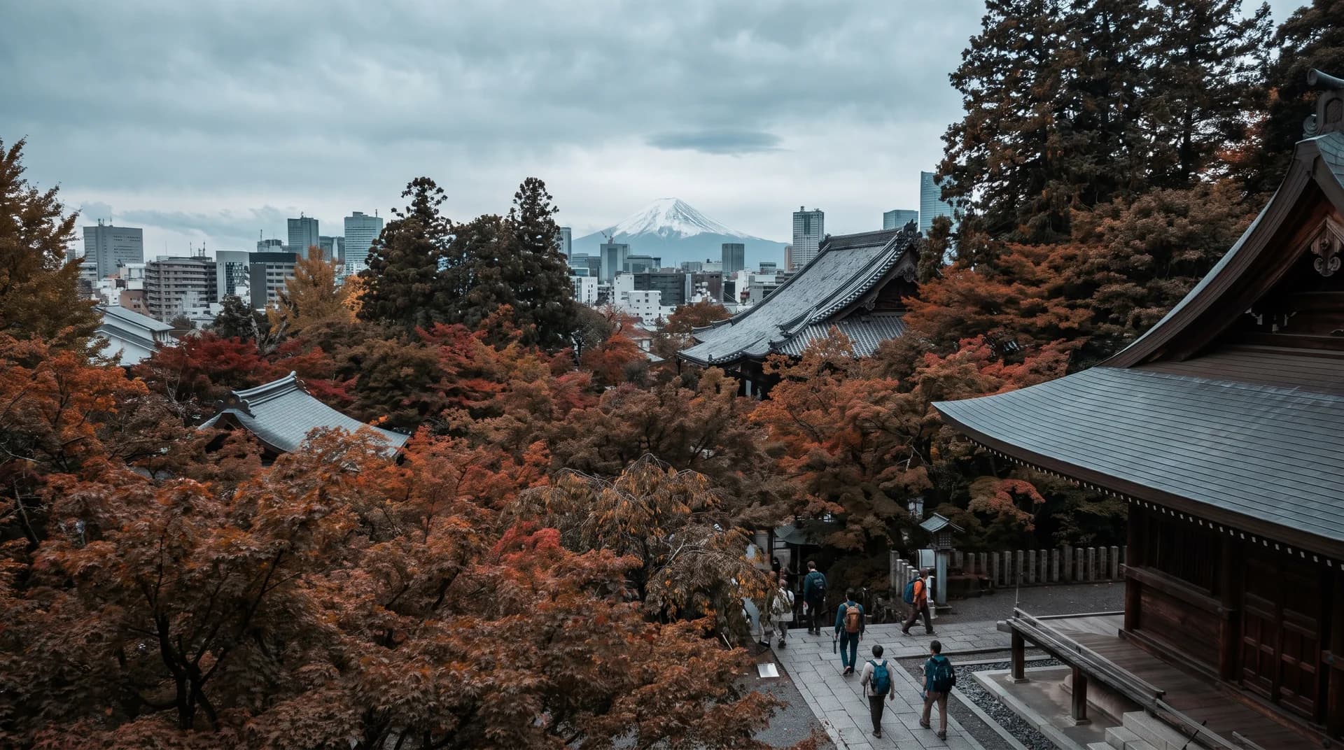 Split screen image showing a neon-lit Shibuya crossing on the left and a snow-capped Mt. Fuji peak on the right.
