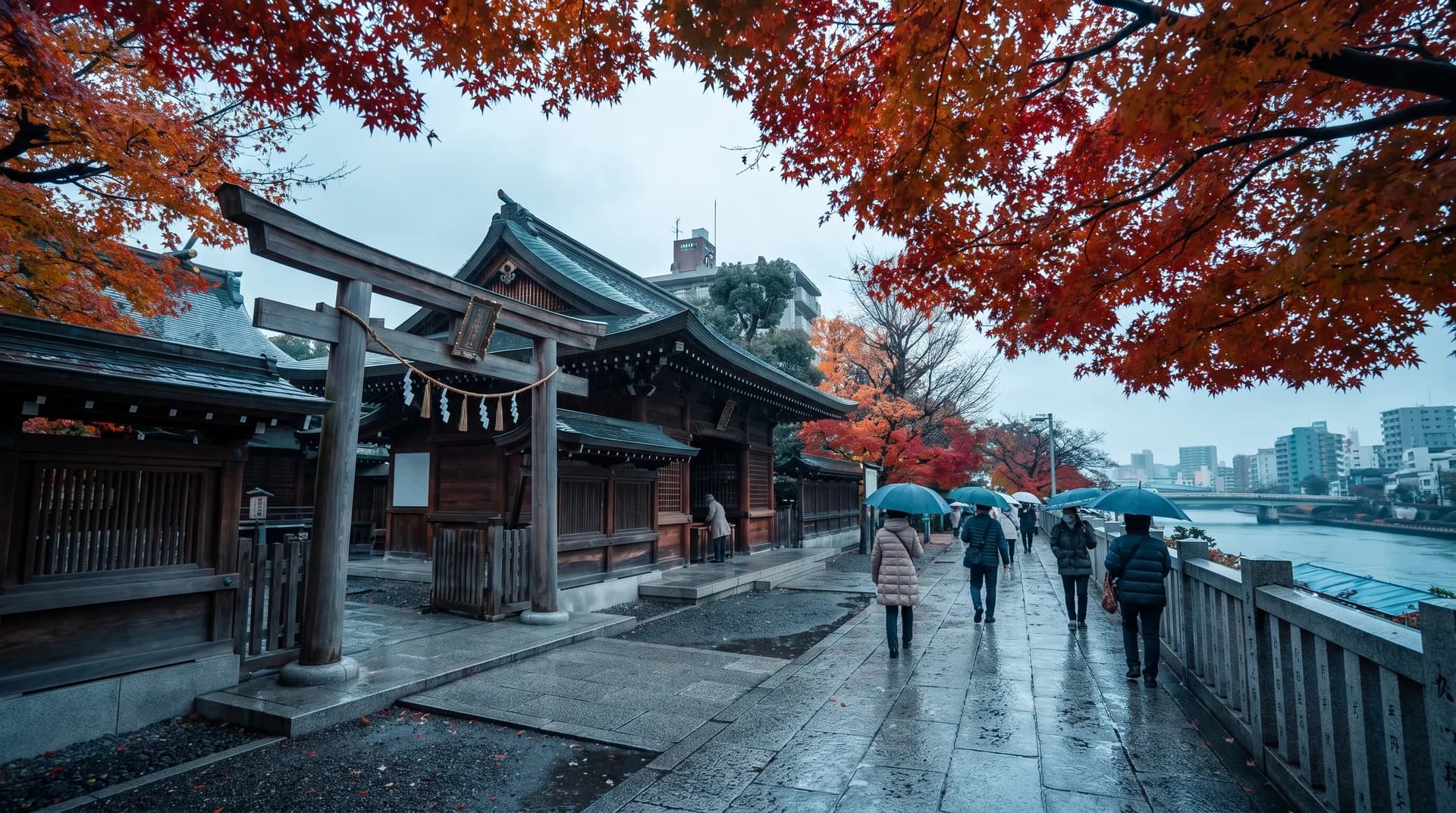 Wide shot of a Tokyo street lined with orange autumn leaves, neon signs, and pedestrians under a clear blue sky.