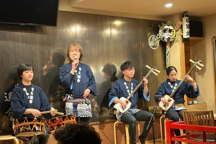 Tsugaru shamisen performance over traditional dinner — photo 1