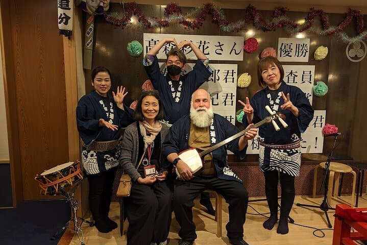 Tsugaru shamisen performance over traditional dinner — photo 12