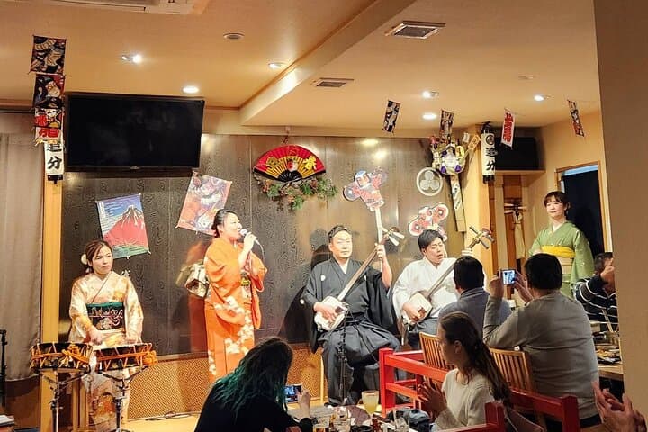 Tsugaru shamisen performance over traditional dinner — photo 3